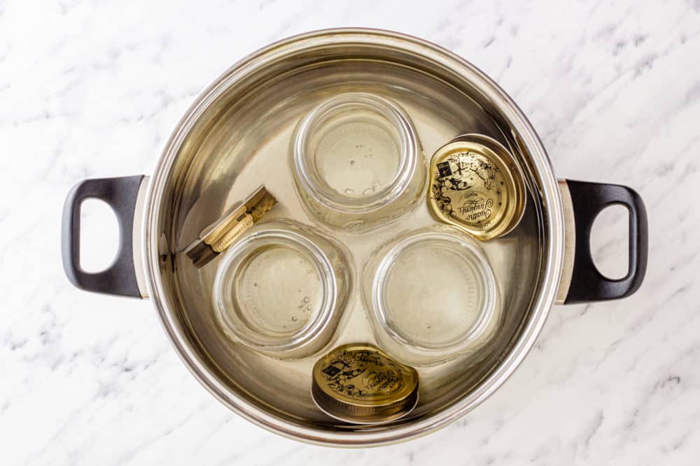 jars and lids in a pot of water.