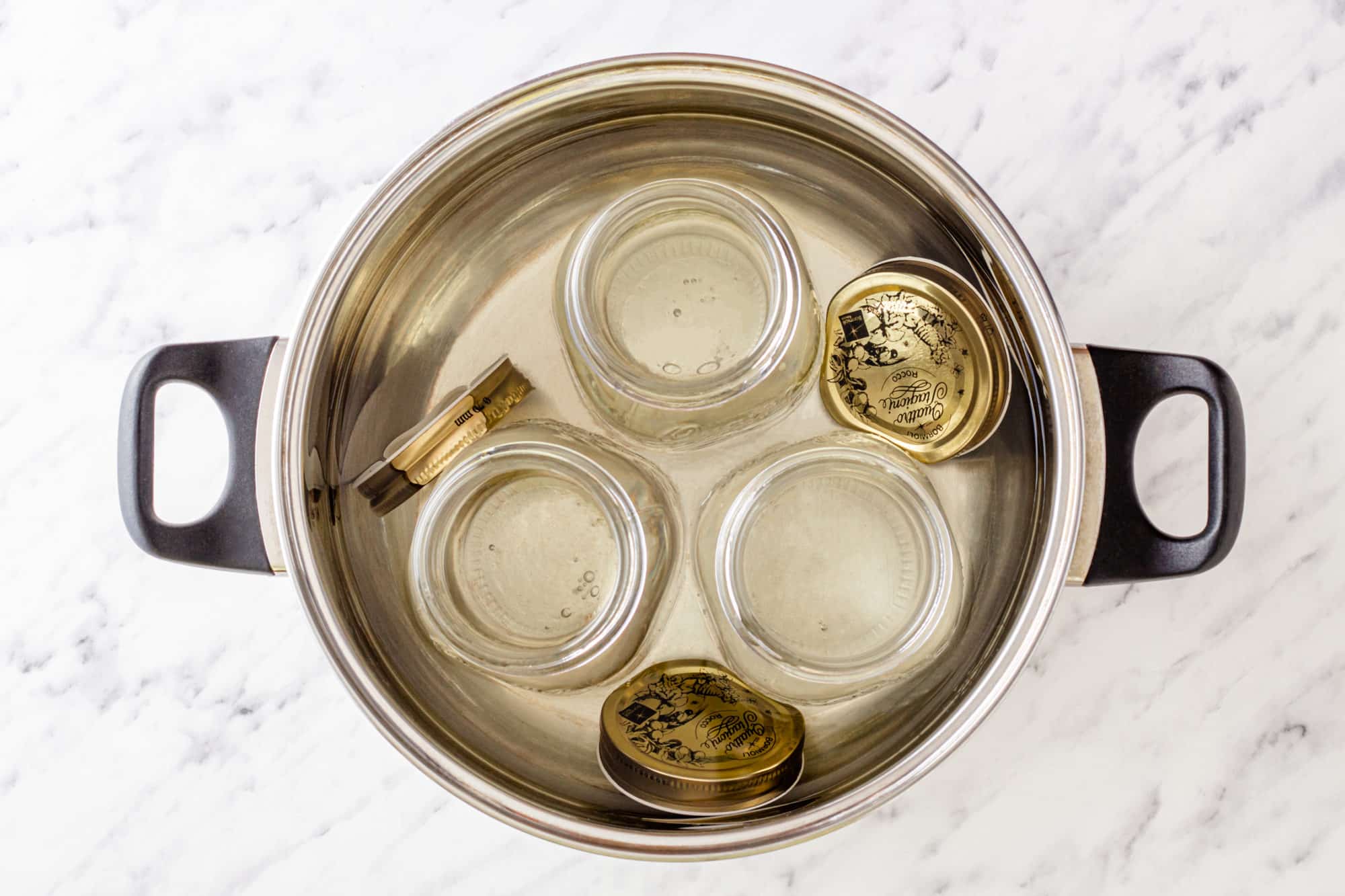 jars and lids in a pot of water.