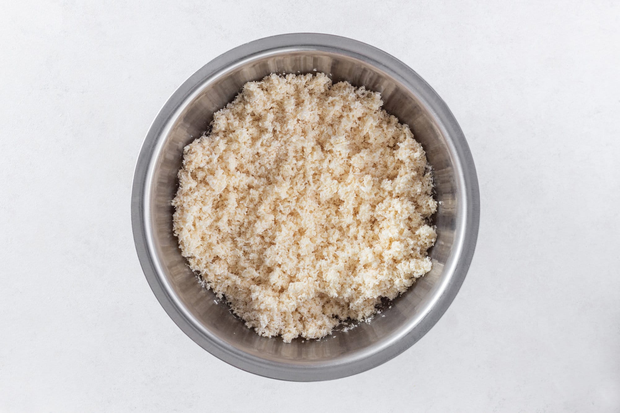 Coconut shreds in a silver bowl.