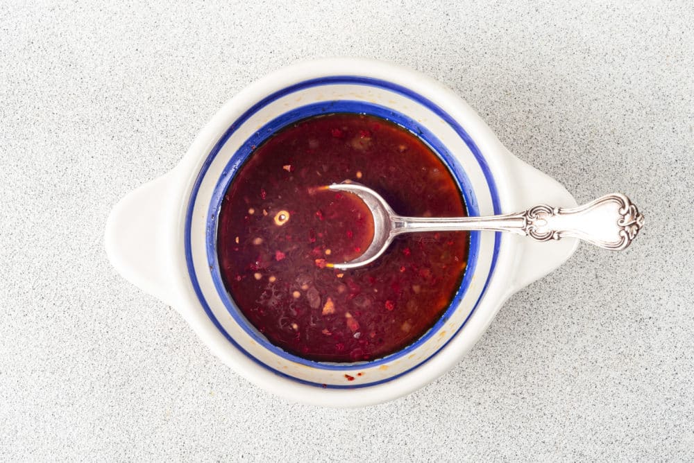 chili garlic sauce in a bowl with a spoon.