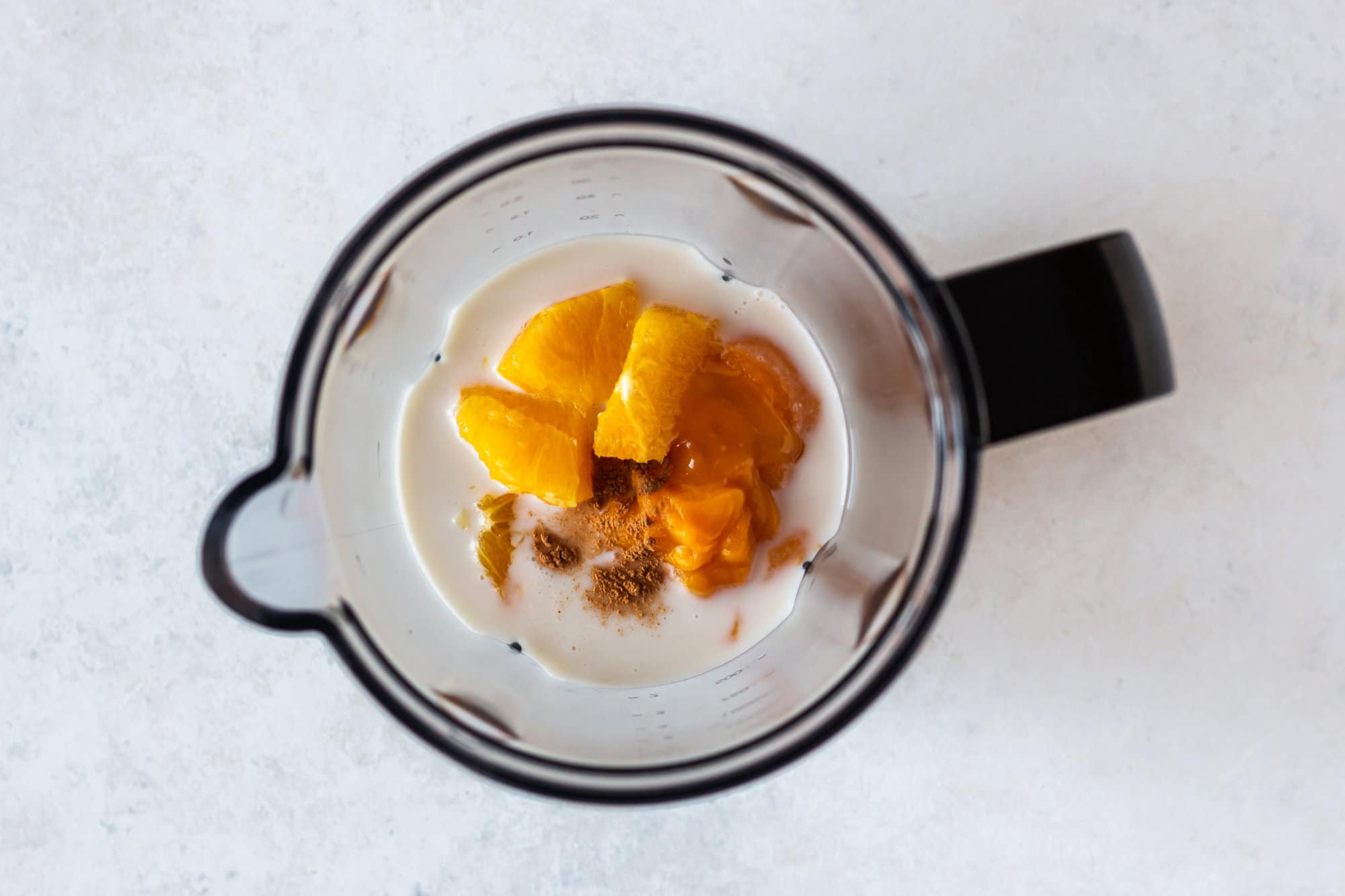 Ingredients for pumpkin pie smoothie in a blender.