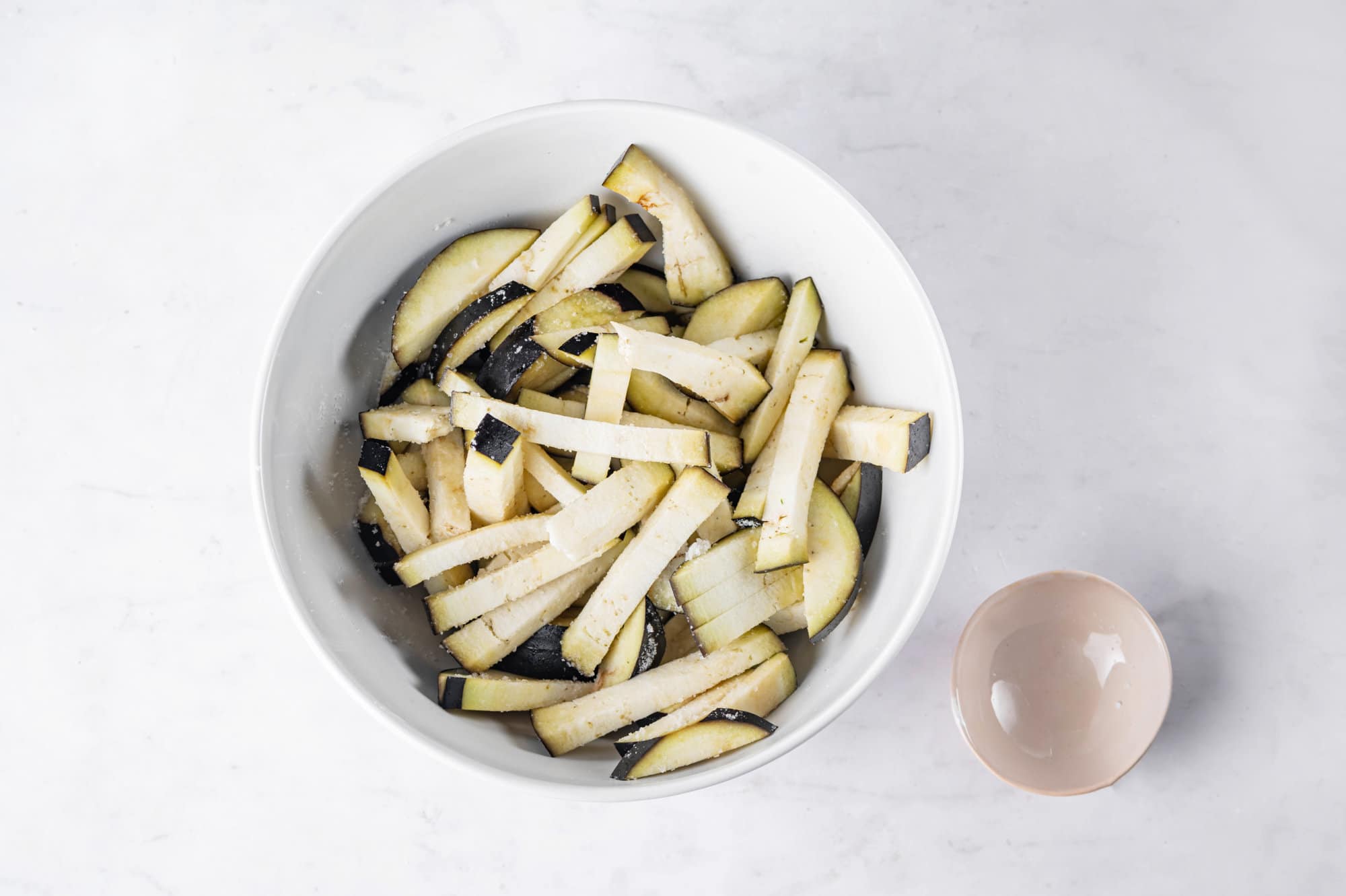 eggplant-salad-chopped-eggplant-in-white-bowl-with-beige-bowl-to-the-side