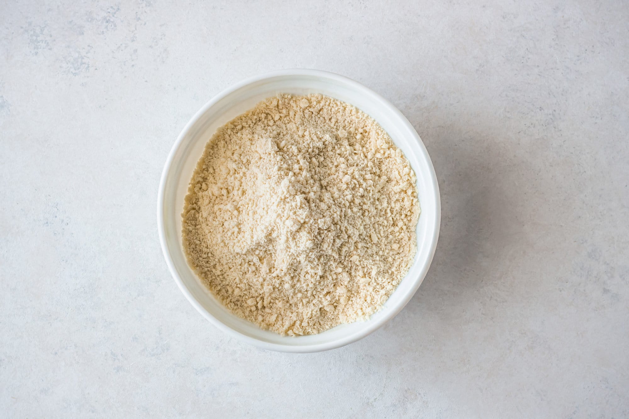 Dry ingredients for apple tart in a white bowl. 