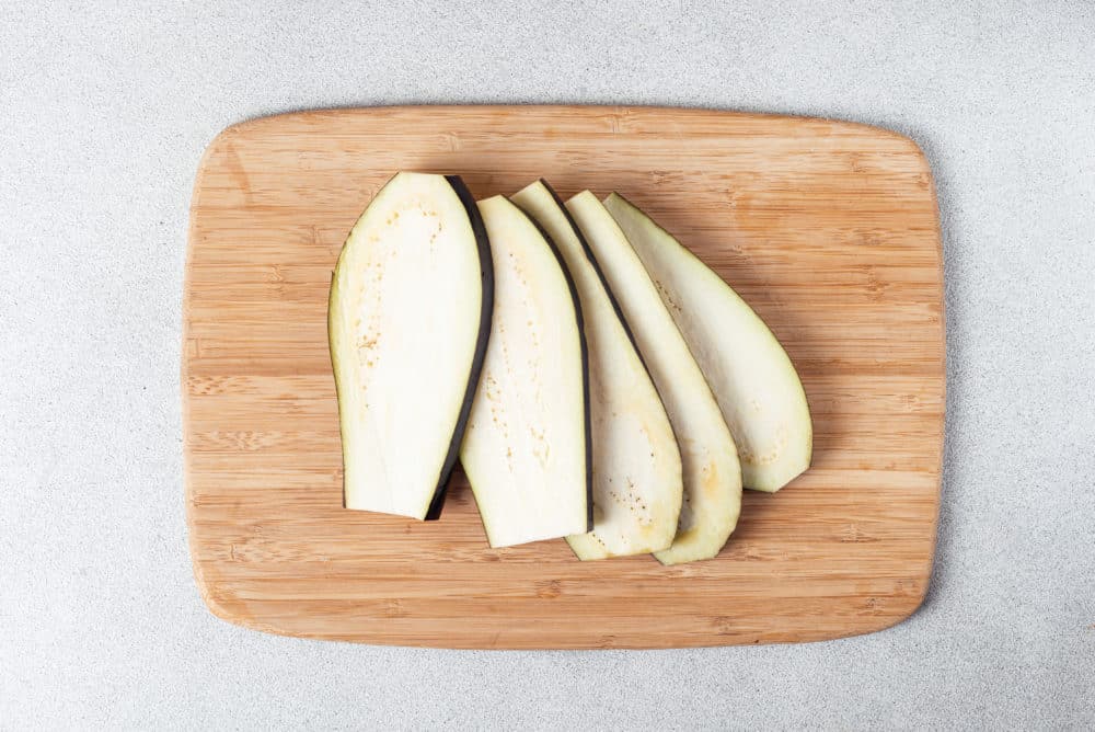 eggplant slices on a cutting board.