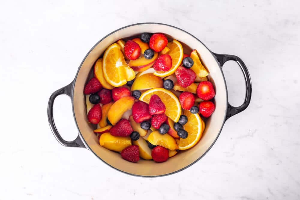 chopped fruits in a large pot.