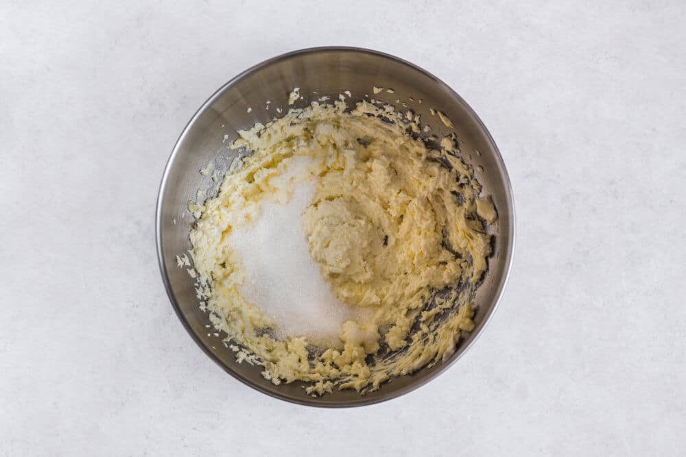 sugar-and-butter-being-mixed-in-a-silver-bowl