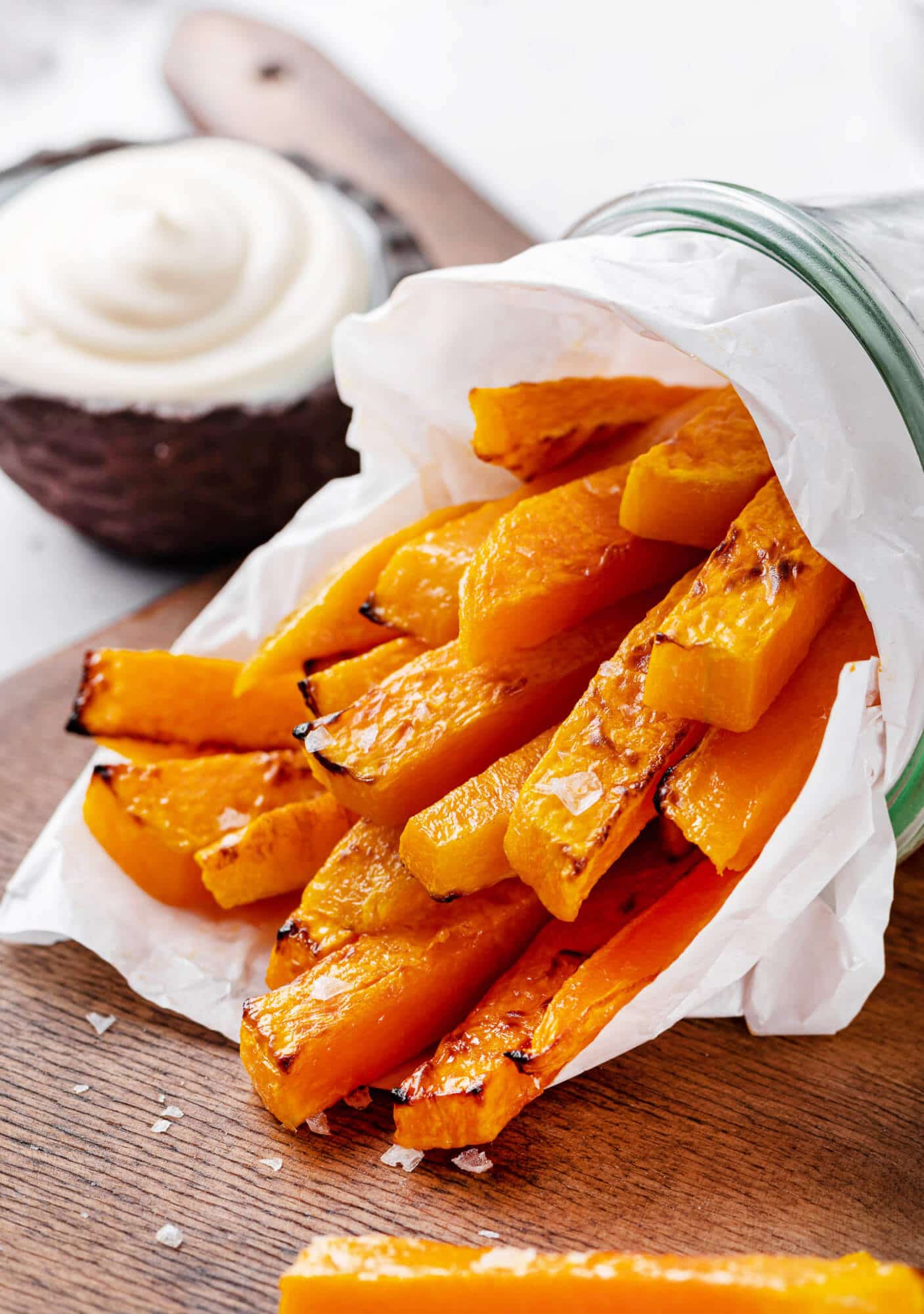 butternut-squash-fries-on-a-wooden-board-in-a-cup-with-sauce-on-the-side