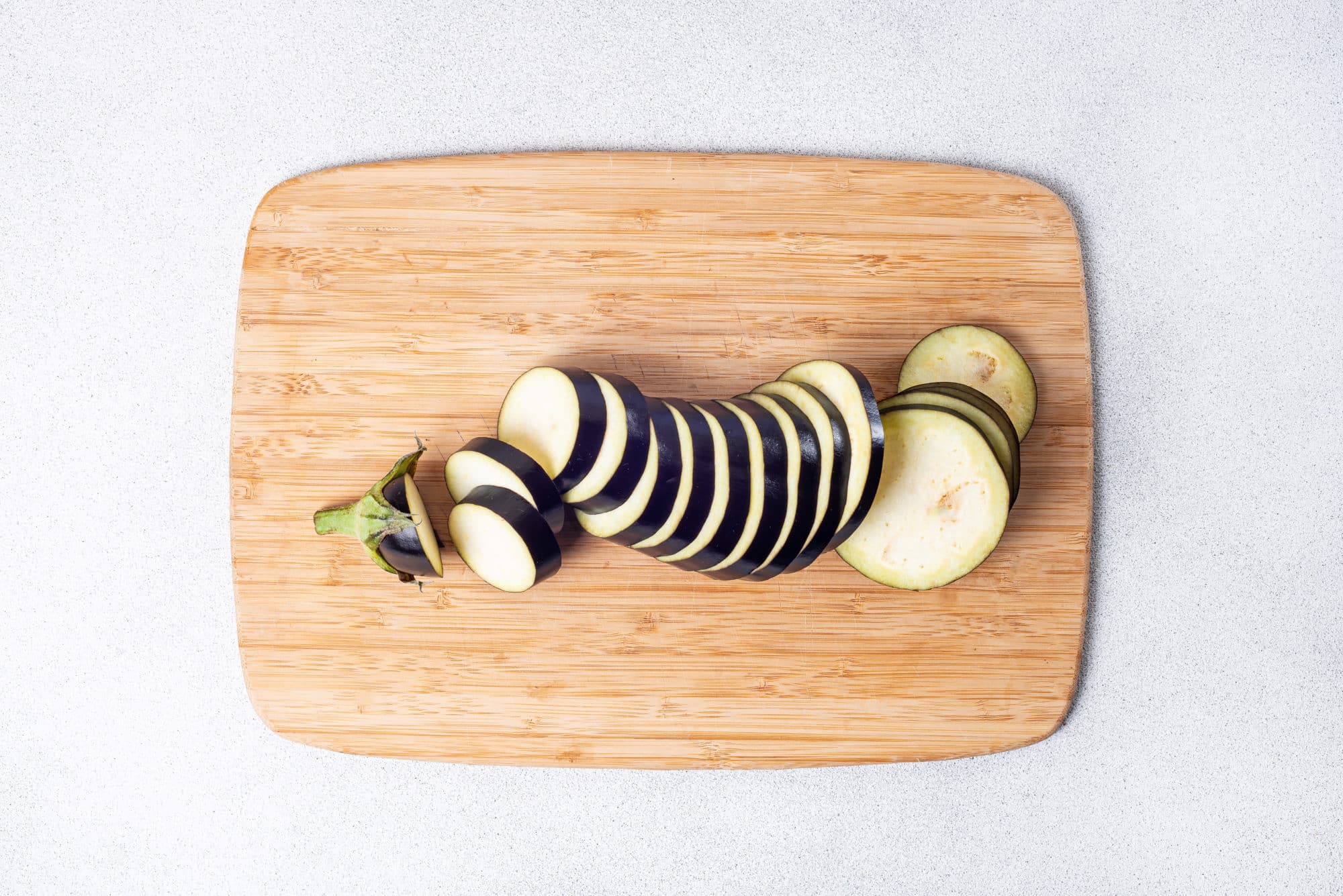 sliced eggplant on a cutting board.