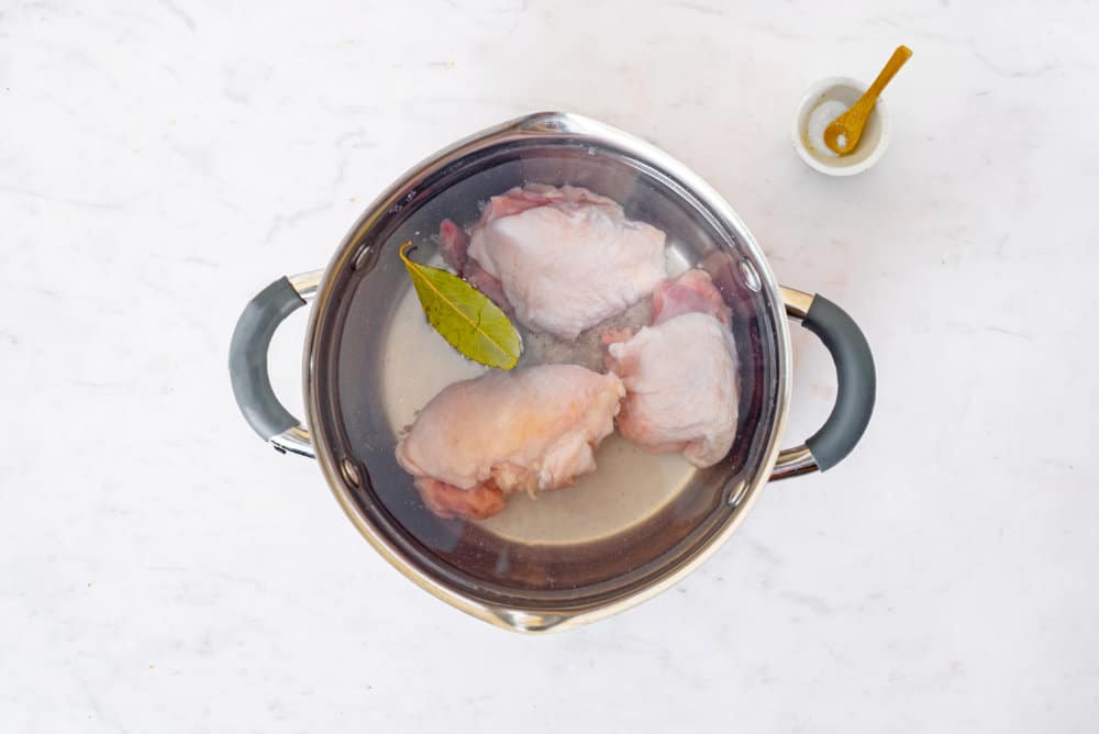 broth-cooking-in-a-silver-soup-pot-with-a-bowl-of-salt-on-the-side