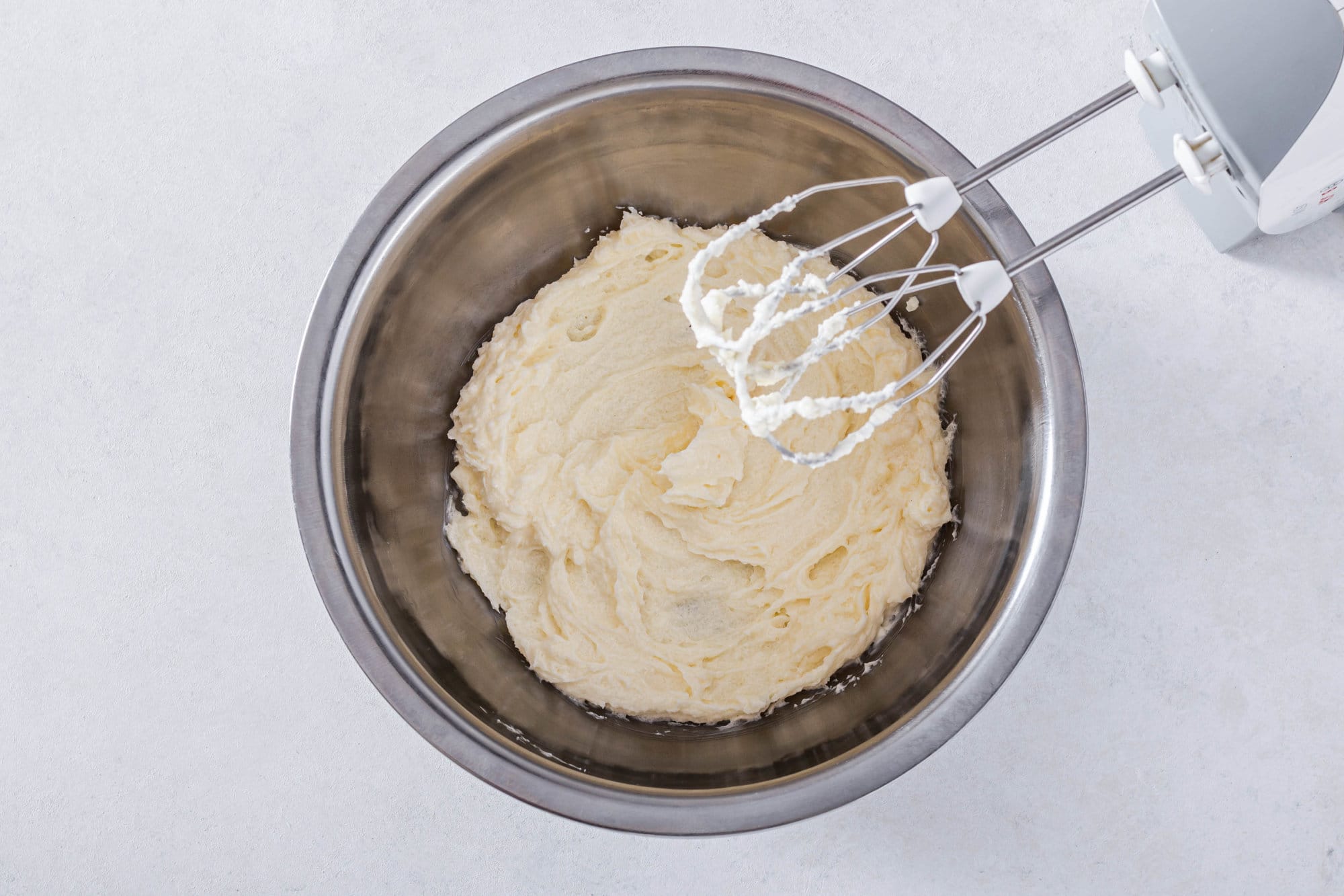 sugar-and-butter-in-a-silver-bowl-with-hand-mixer