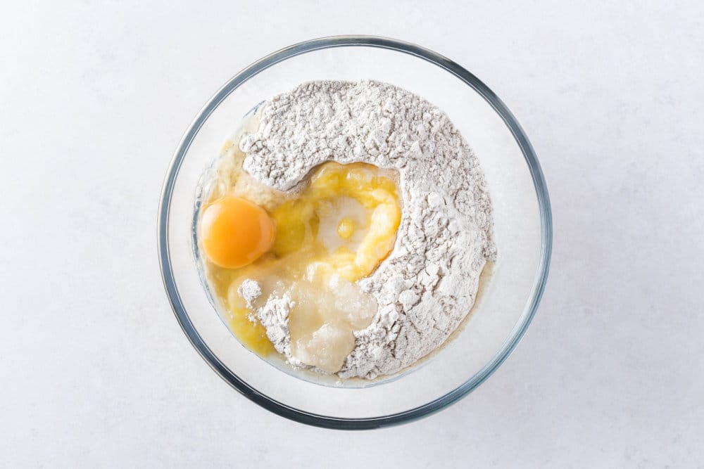 Ingredients for Russian vatrushka bun dough in a glass bowl.