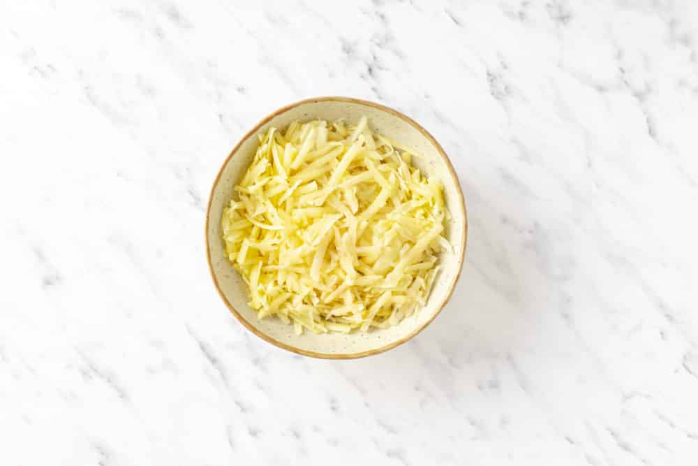 grated raw potato in a bowl.