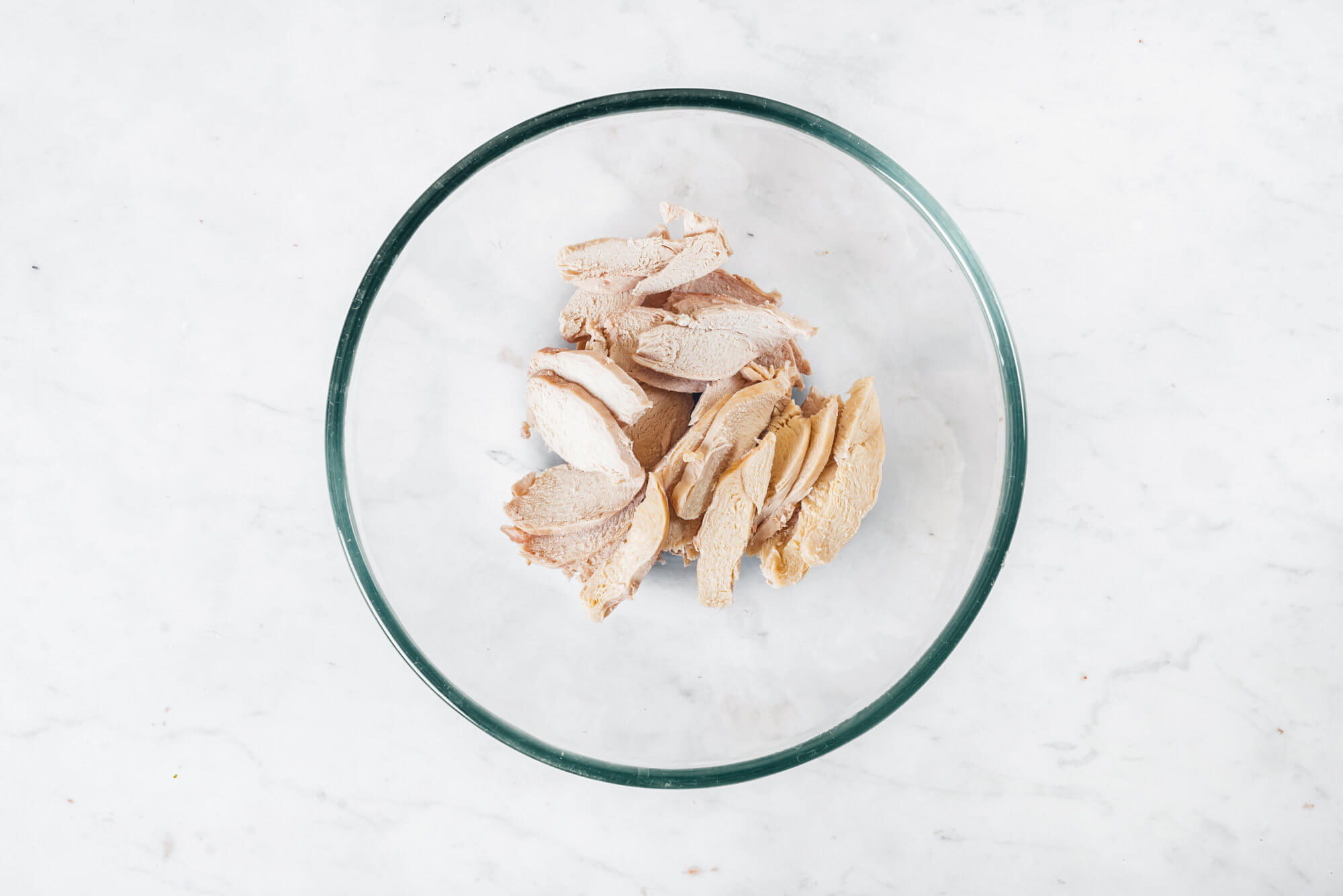 cooked sliced chicken breast in a bowl.