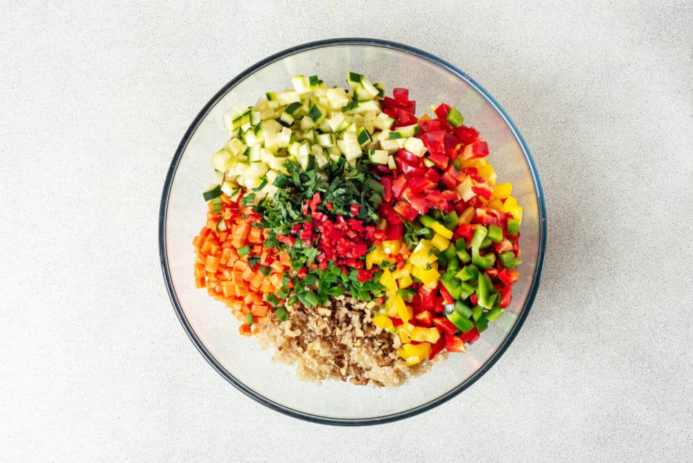 chopped salad ingredients in a glass bowl.