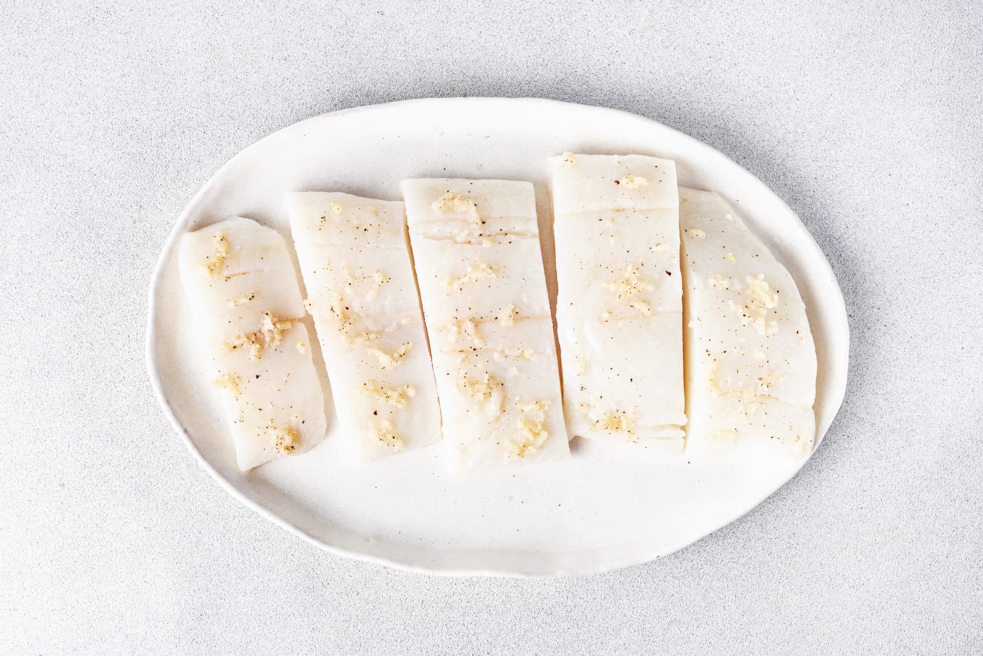 raw-halibut-filets-on-a-white-plate