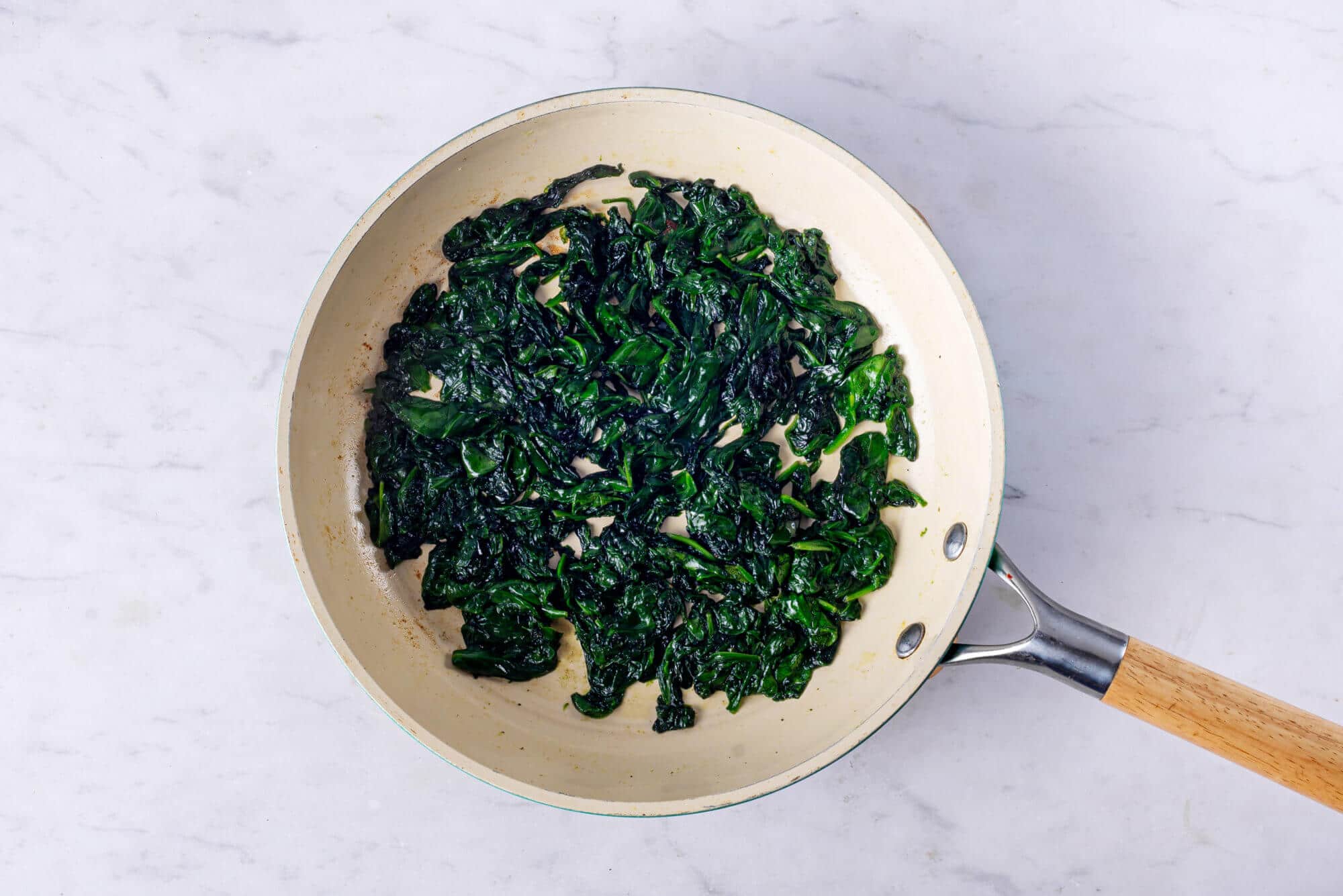 Spinach sauteed in a skillet. 