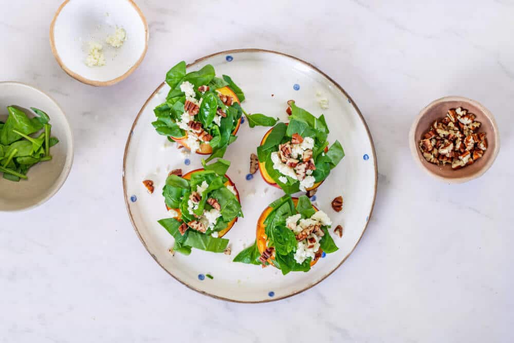 nectarine-salad-on-a-white-plate-with-a-bowl-of-walnuts