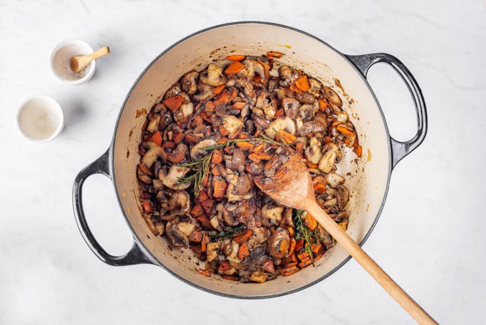 Veggies and spices in a pot.