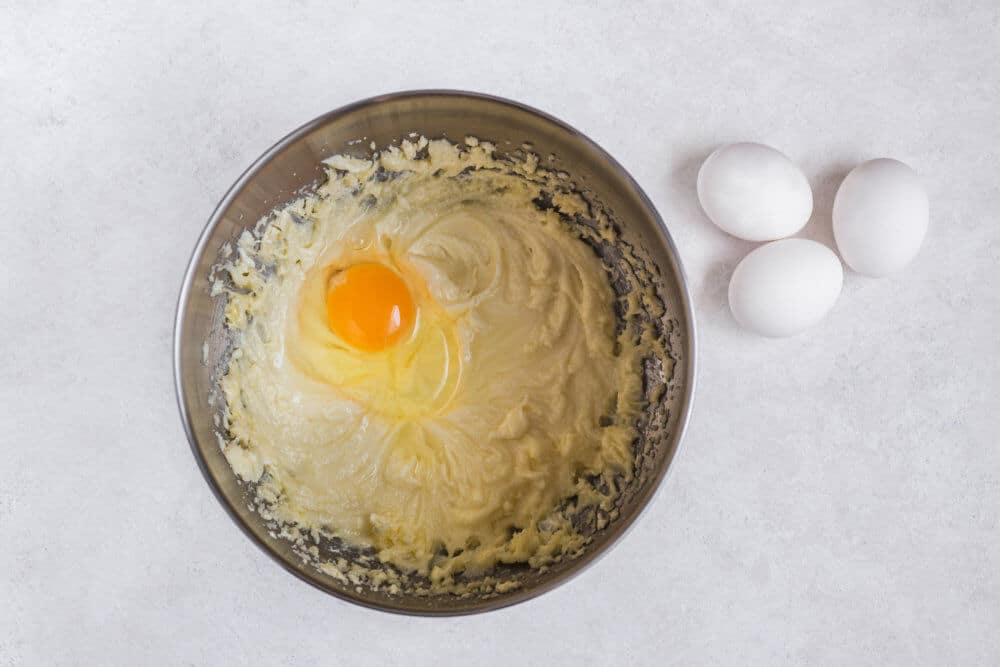 apple-tart-batter-ingredients-in-a-bowl-with-eggs-on-the-side