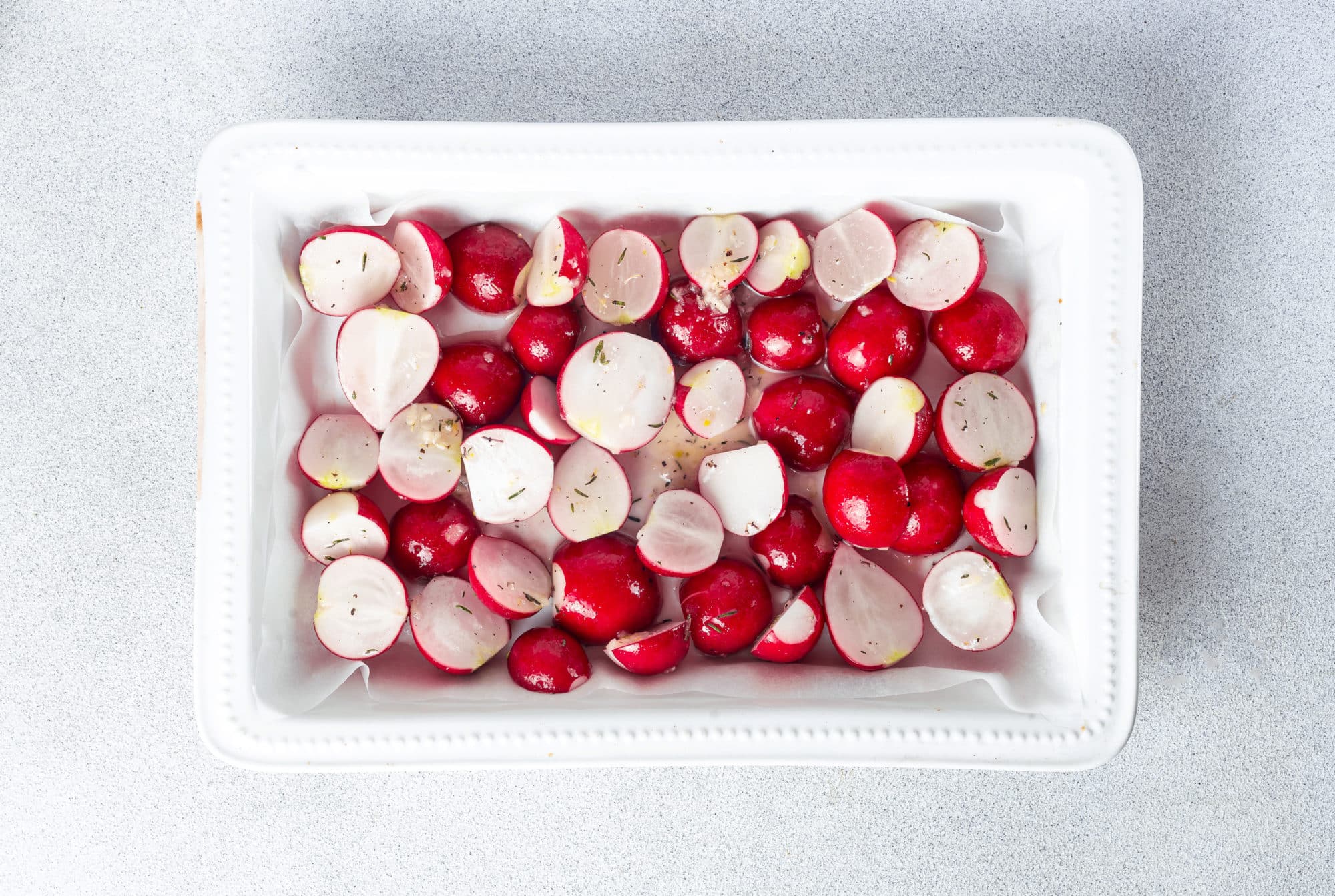 raw fresh radishes in a baking dish.