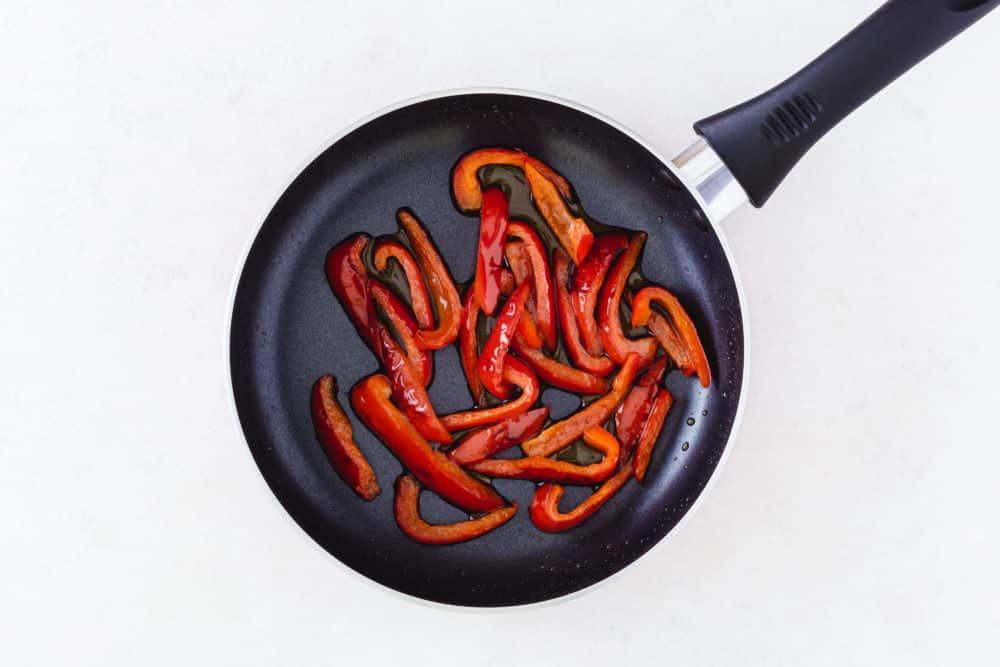 Bell peppers and olive oil in a skillet.