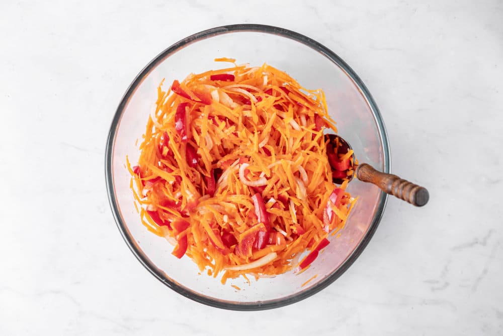 marinated-eggplant-salad-carrots-and-red-bell-pepper-chopped-in-a-clear-bowl-with-a-spoon