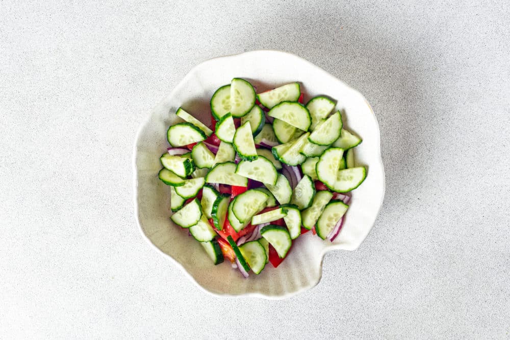 tomatoes-cucumber-and-red-onion-in-a-white-bowl