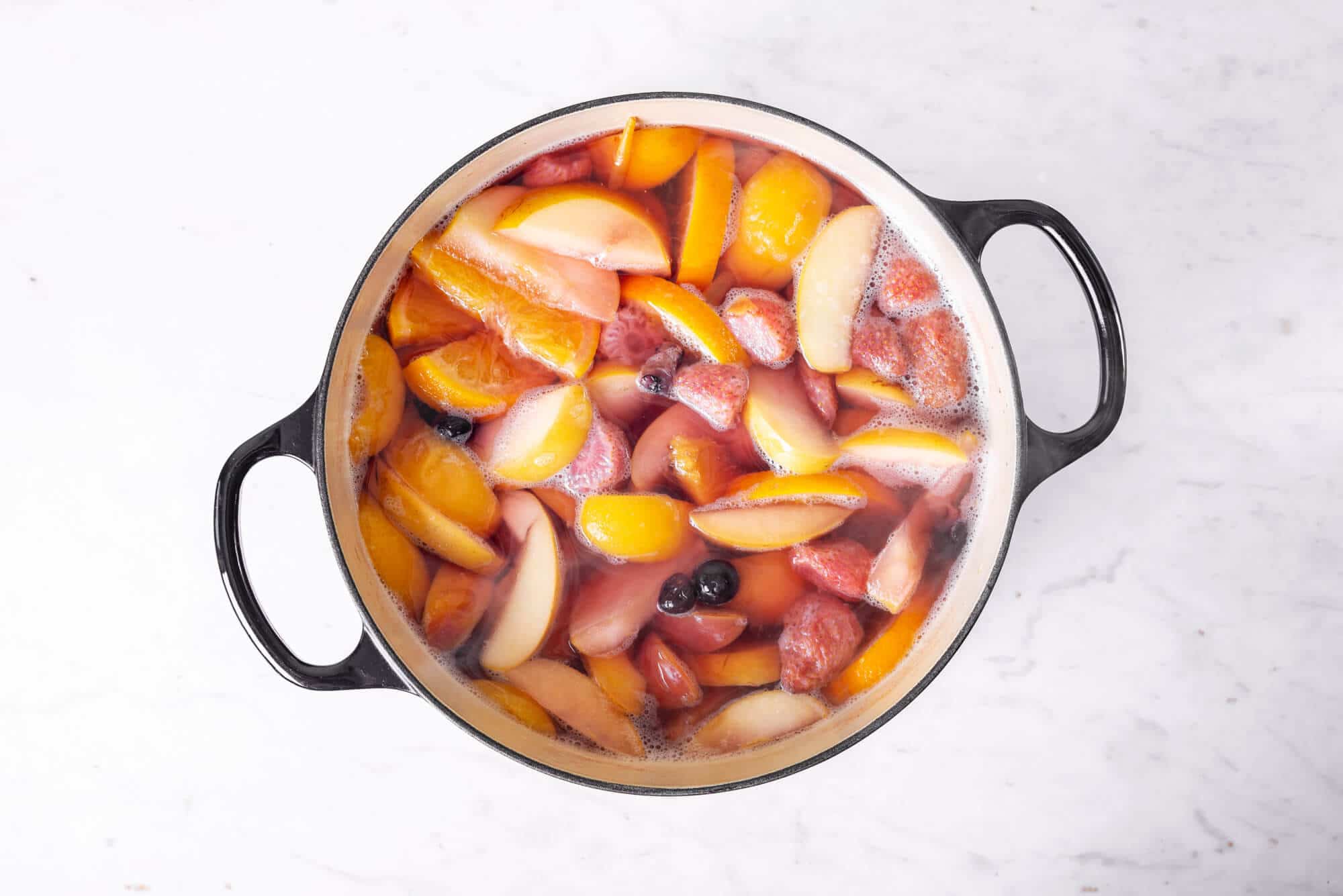 fruits-and-water-simmering-in-a-large-pot