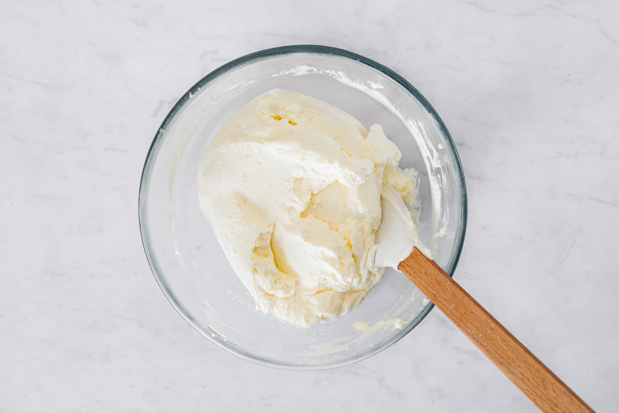 cheesecake-filling-in-a-clear-bowl-with-a-spatula