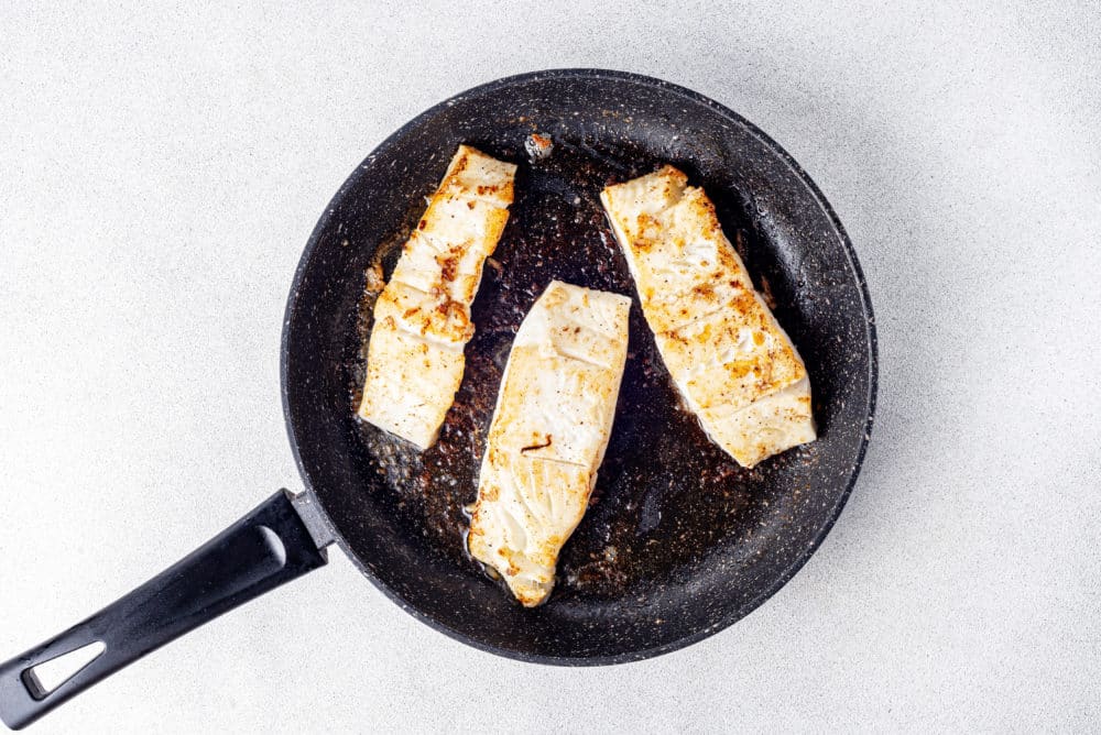 halibut-filets-sauteing-in-a-black-skillet