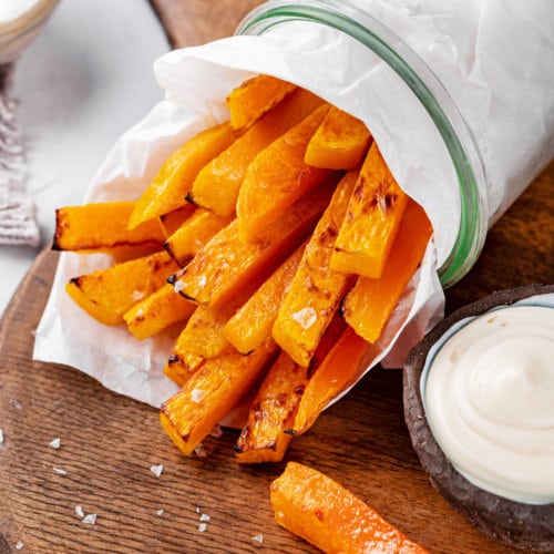 butternut-squash-fries-on-a-wooden-board-in-a-cup-with-sauce-on-the-side