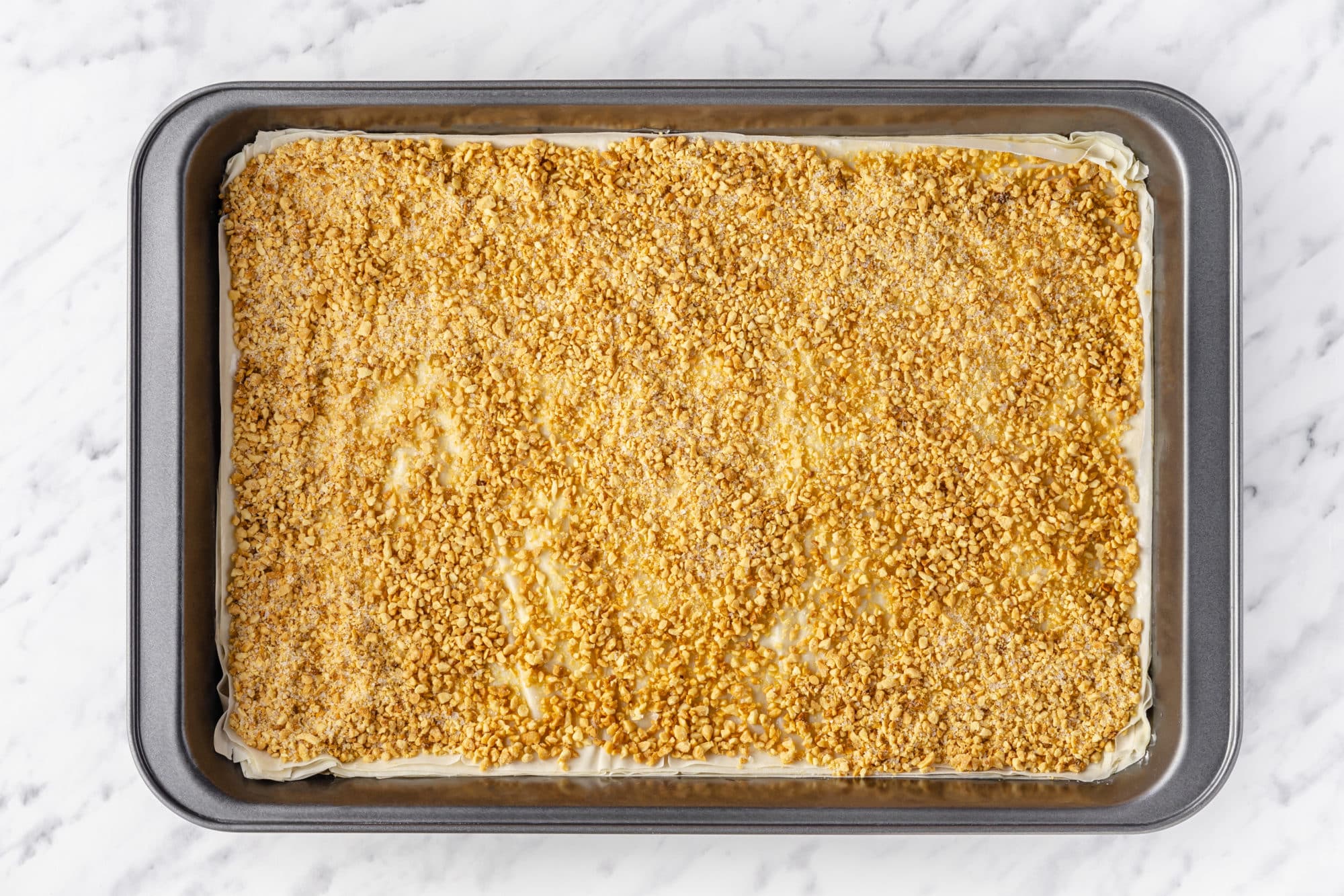 layers of baklava in a baking tray.