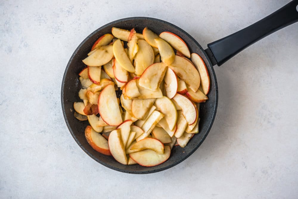 apple slices in a skillet.