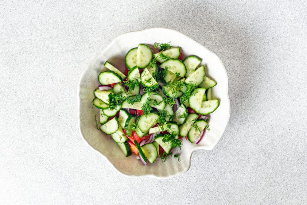 tomatoes-cucumbers-red-onion-and-dill-in-a-white-bowl