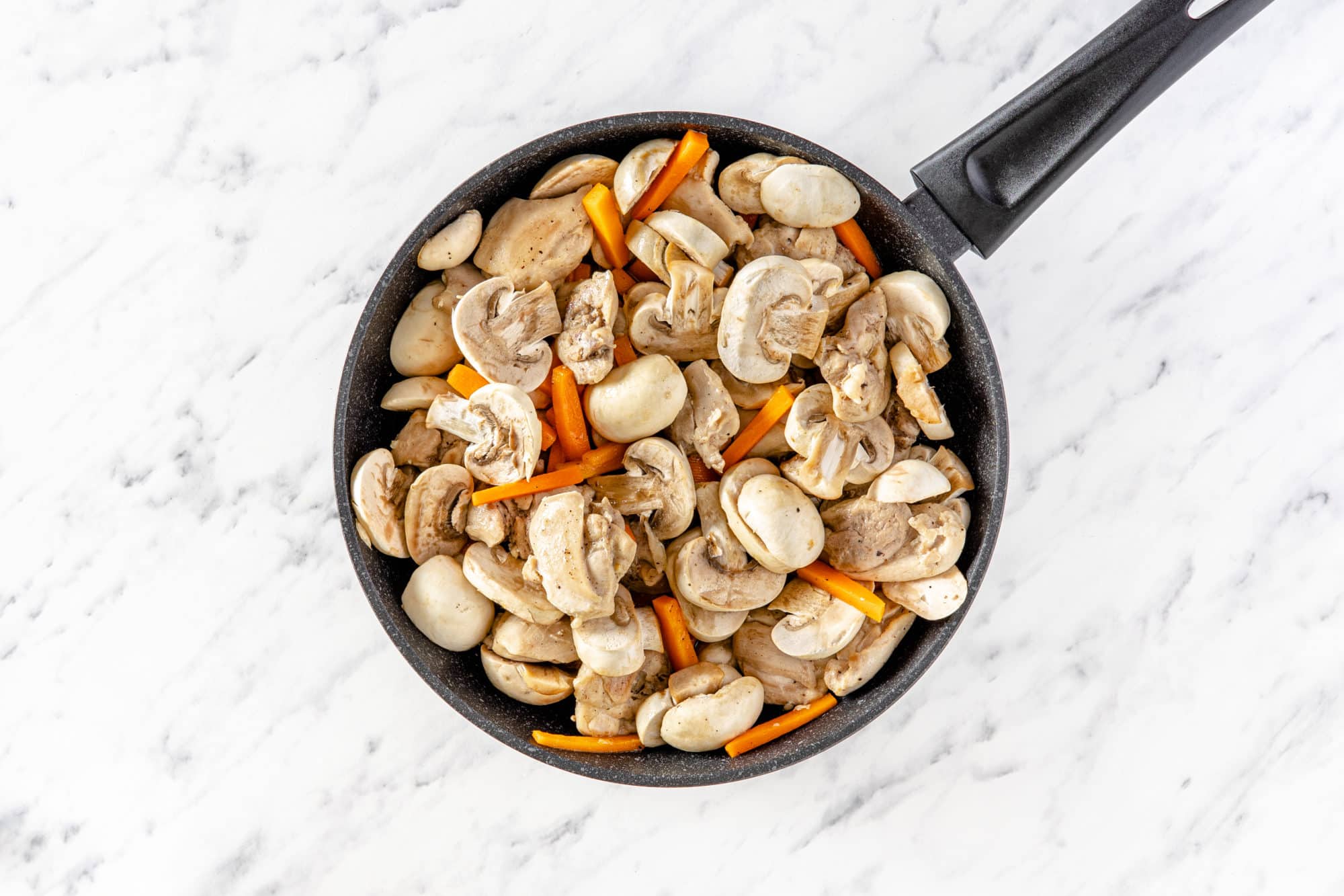 veggies in a pan with chicken.