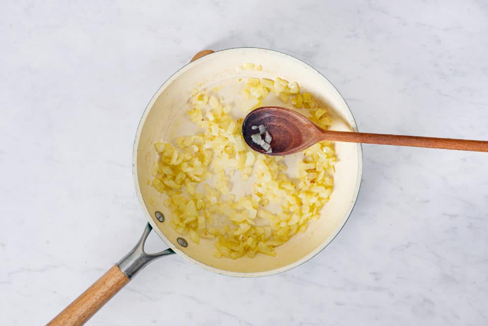 onion-sauteing-in-a-skillet-with-a-wooden-spoon