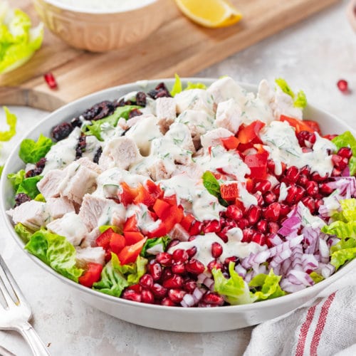 Left over turkey salad recipe with dressing in a white bowl.