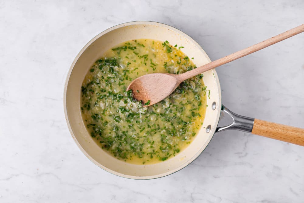 sauce-for-capellini-pasta-in-a-skillet-with-a-wooden-spoon