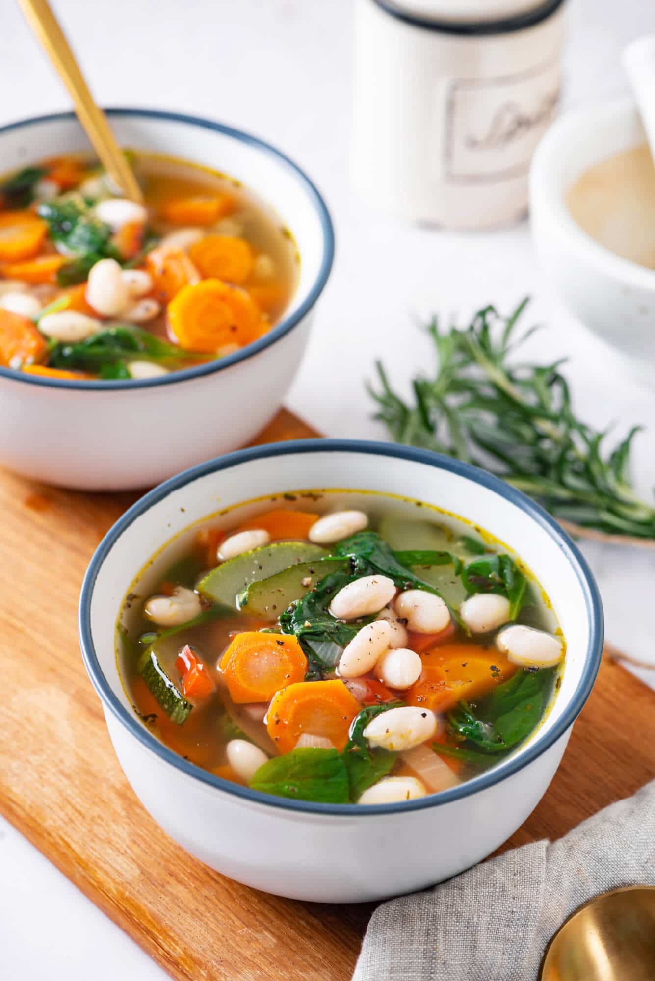 tuscan-soup-in-a-bowl-on-a-wooden-board-with-rosemary