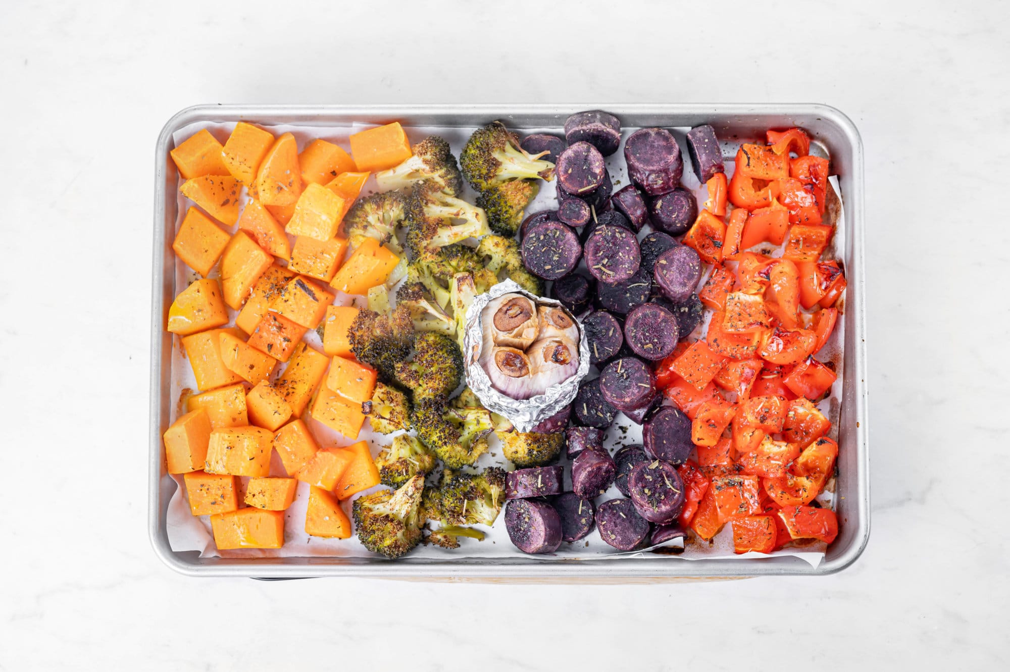 veggies all roasted fresh out of the oven on a baking tray with garlic.