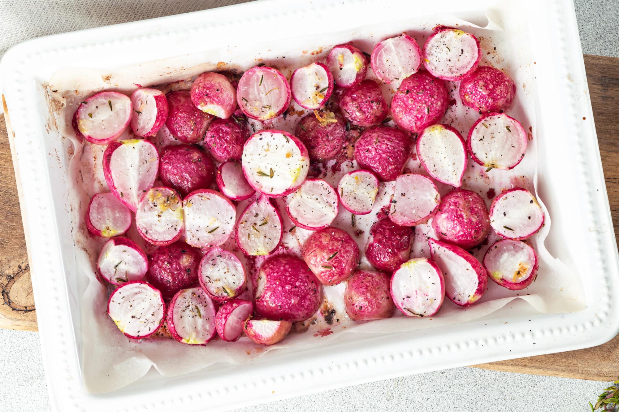 roasted radishes in a white baking dish.