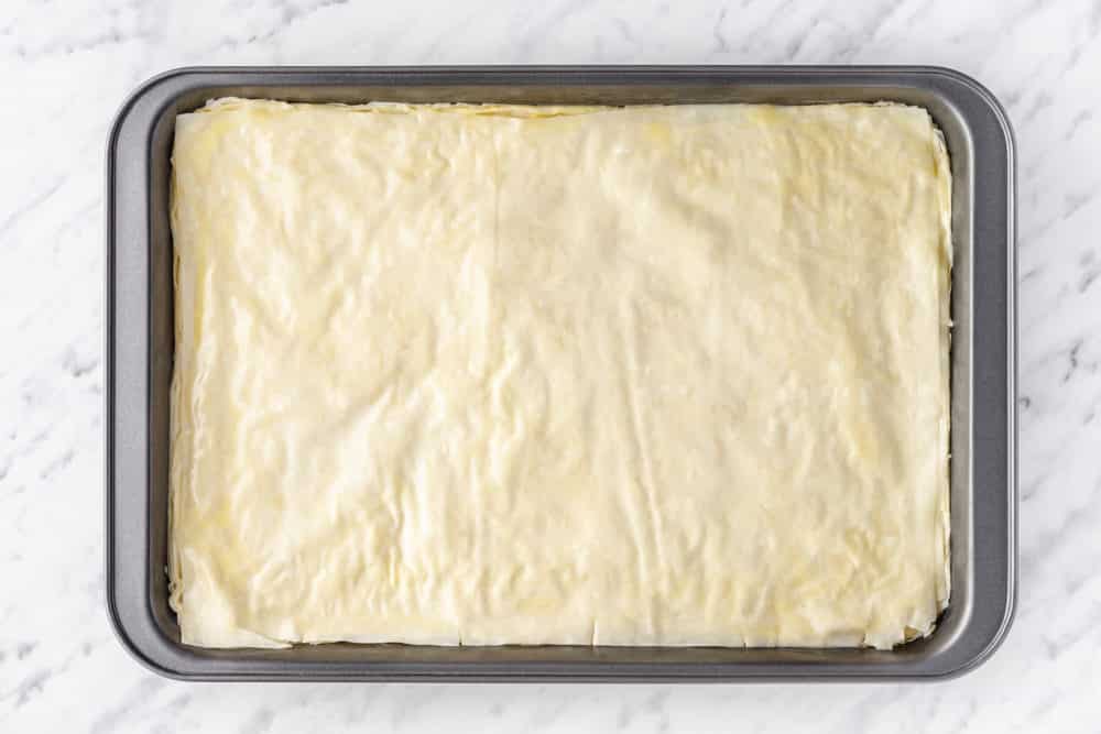 baklava top layer raw in a baking tray.