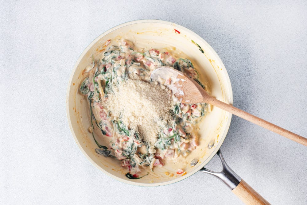 stuffing for mushroom mix in a skillet with cheese on top.