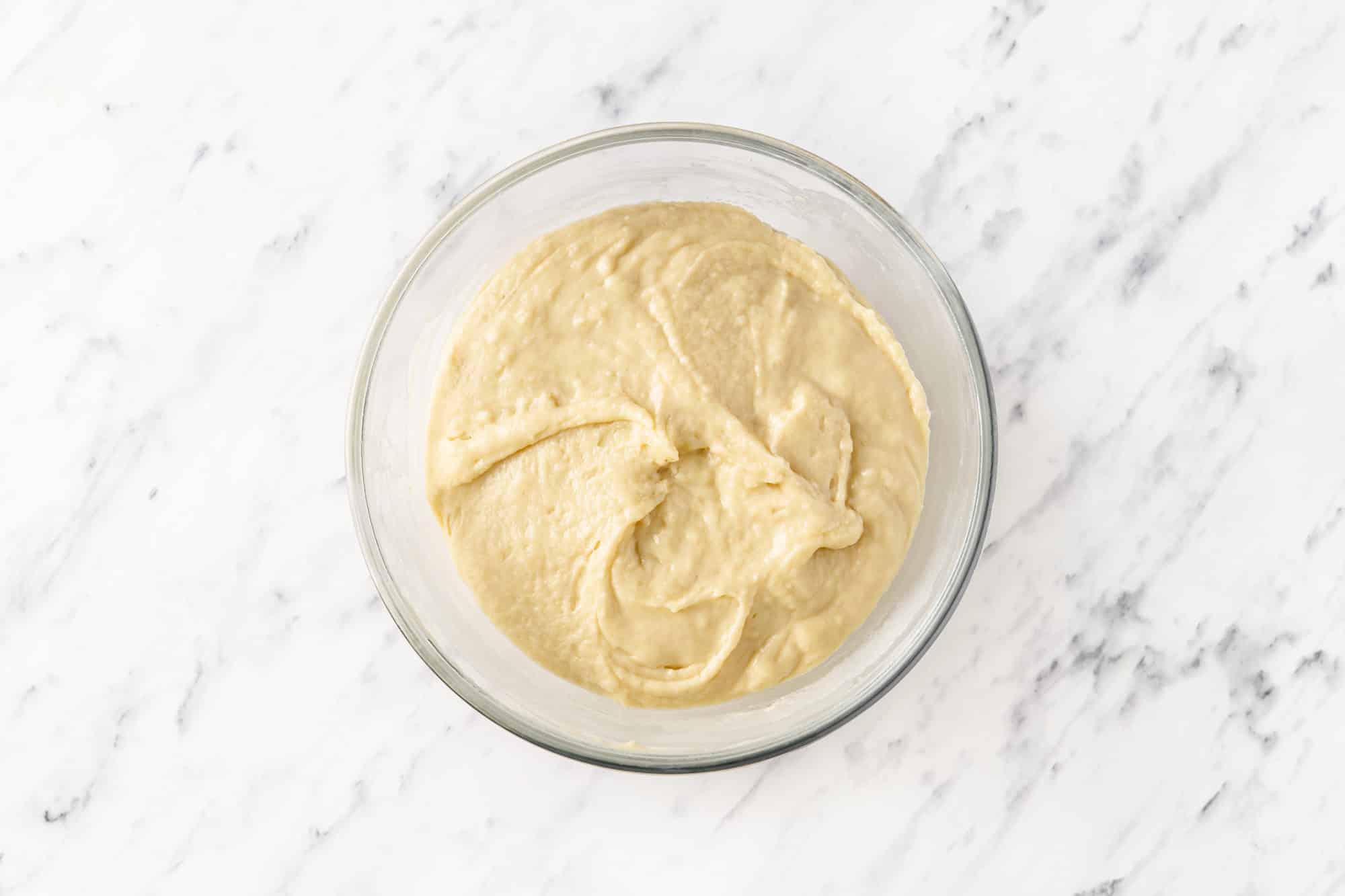 raw dough in a glass bowl.