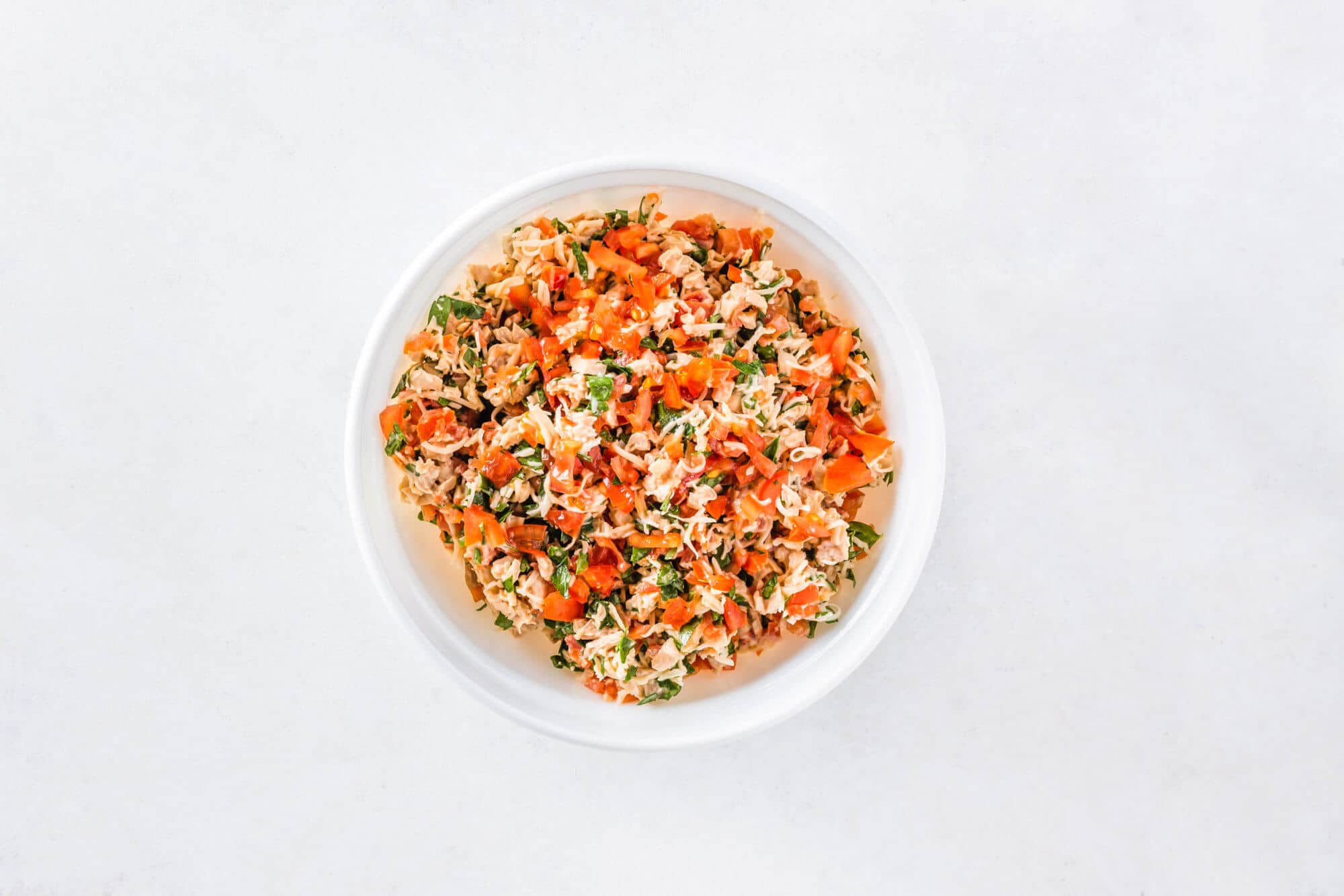 Bruschetta topping in a white bowl.