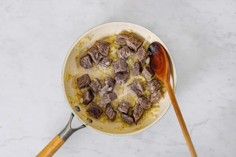 beef-sauteing-in-a-skillet-with-a-wooden-spoon