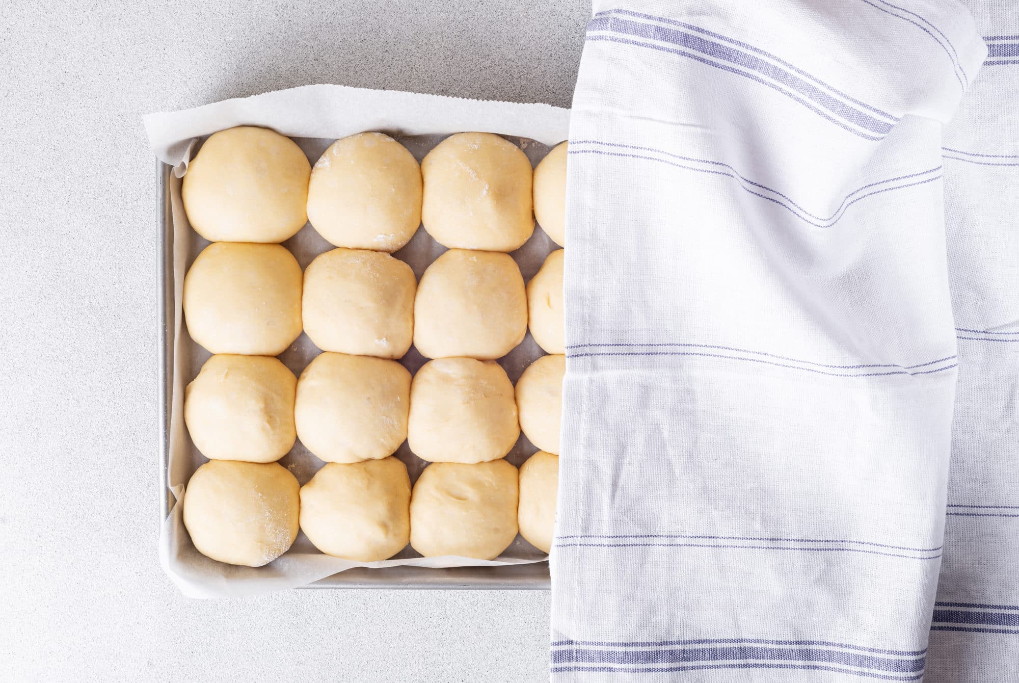 raw-buns-on-baking-sheet-with-towel