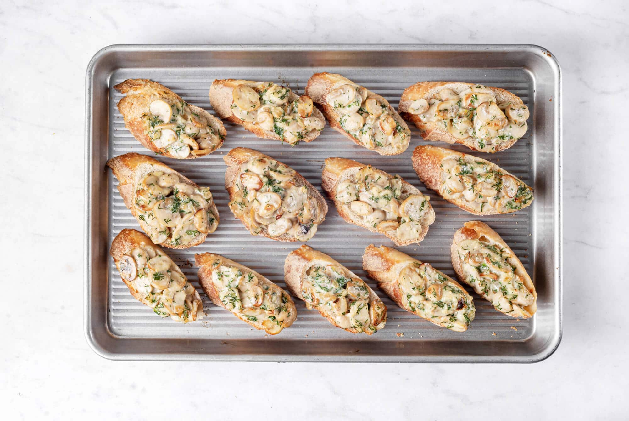 Baked mushroom crostinis on a tray.