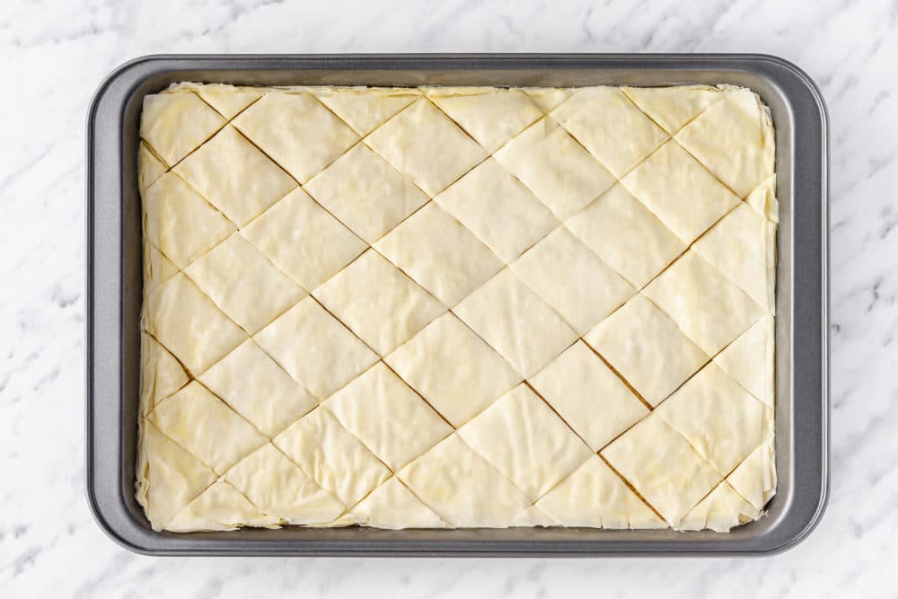 prepared baklava cut in a baking tray.