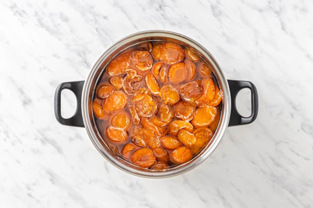 apricot jam cooking in a soup pot.